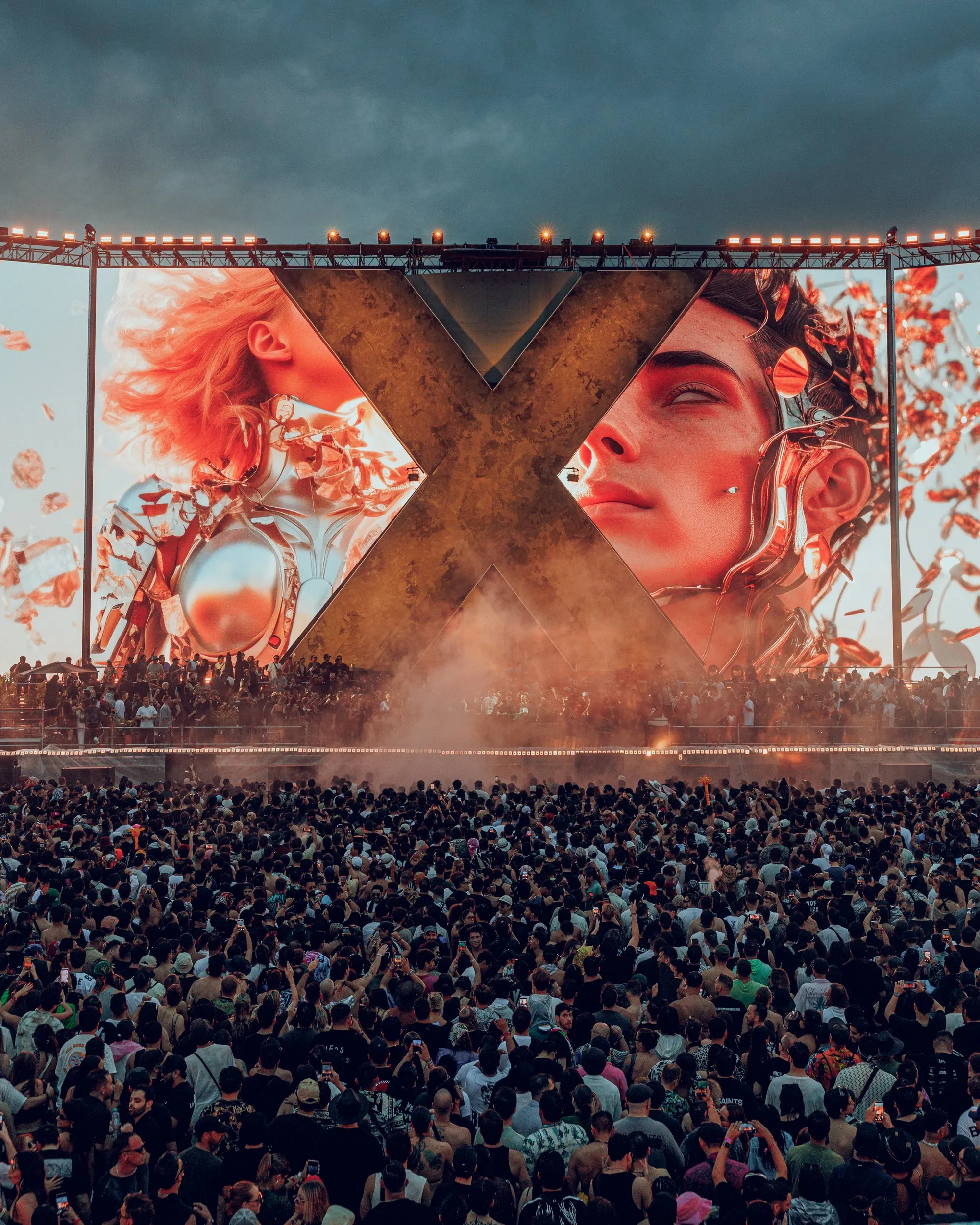 Zamna crowd facing a giant X stage with digital artwork